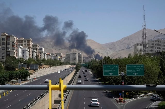 Smoke rises from an oil storage facility after it appeared to have been struck by an Israeli strike on in Tehran. (VAHID SALEMI/AP)