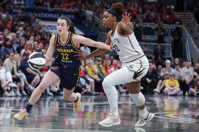 Caitlin Clark #22 of the Indiana Fever dribbles against Kennedy Burke #22 of the New York Liberty at Gainbridge Fieldhouse on June 14, 2025 in Indianapolis, Indiana.