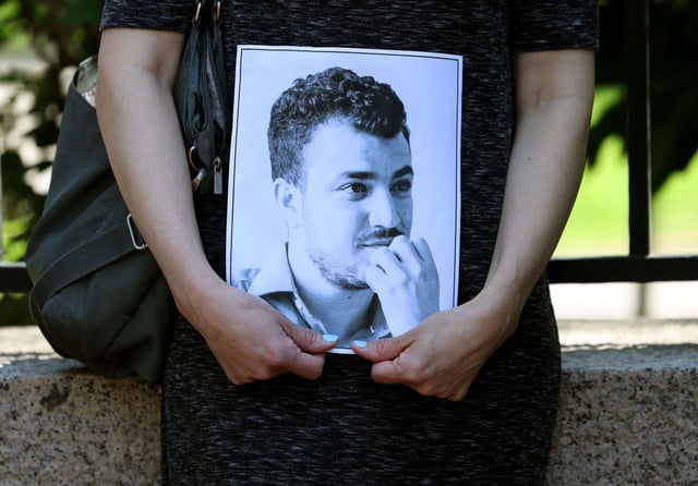 A protester holds an image of Mahmoud Khalil, a graduate student at Columbia who played a significant role in the student protests against Israel's war on Gaza before being picked up by ICE as she stood with others at a press conference at Harvard University in Cambridge, Massachusetts, May 12, 2025.