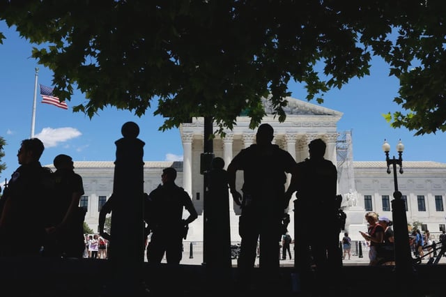 Protesters form a silhouette outside the Supreme Court in Washington, D.C.