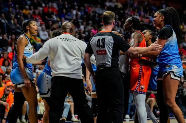 Players, coaches and officials get between Angel Reese of the Chicago Sky, left, and the Sun&#39;s Tina Charles, second from right, during the Sky&#39;s victory on Sunday at Mohegan Sun Arena. (Joe Buglewicz/Getty Images)