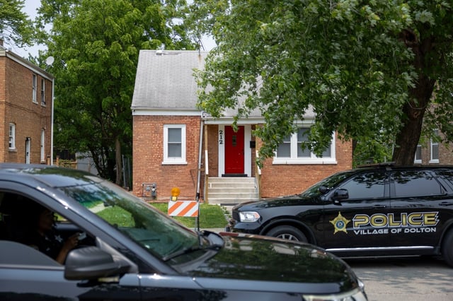 Dolton police sit June 10, 2025, outside the former Prevost family home where Pope Leo XIV grew up at 212 East 141st Place in Dolton. (Brian Cassella/Chicago Tribune)
