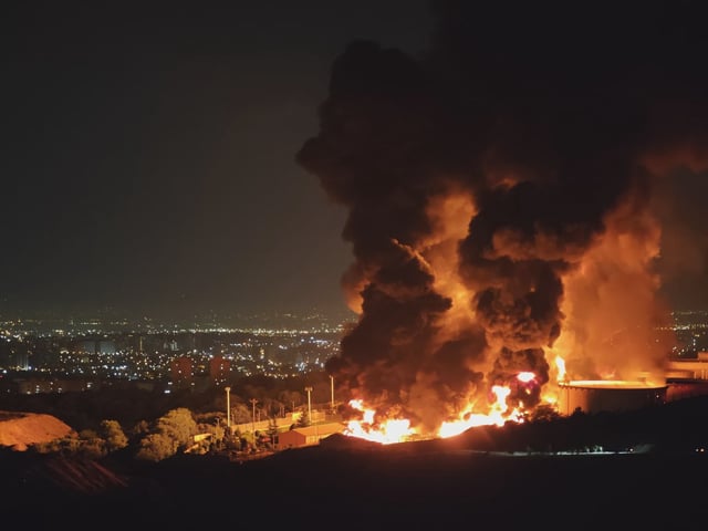 Fire and smoke rise into the sky after an Israeli attack on the Shahran oil depot on Sunday.