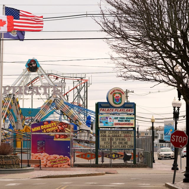 American and Canadian flags fly near the Palace Playland amusement park in Old Orchard Beach, Maine, in April. Many travellers who cross into the U.S. have concerns about safety or disruptions.