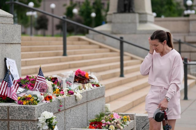 Leah Palmer visits a makeshift memorial for Minnesota state Rep. Melissa Hortman and her husband, Mark, at the state Capitol on Sunday, June 15, 2025, in St. Paul, Minn. (AP Photo/George Walker IV)