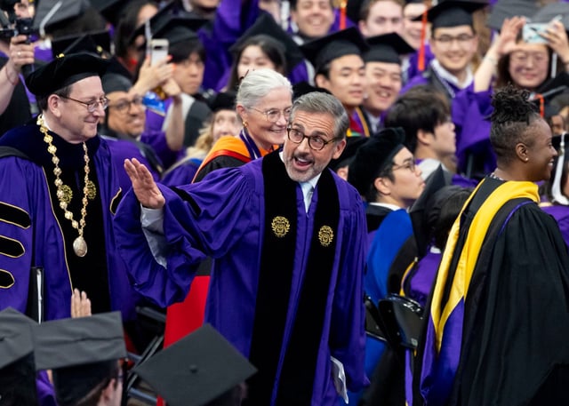 Actor-comedian Steve Carell waves to graduates during Northwestern University’s commencement, June 15, 2025, at the United Center. University President Michael Schill is at left. Carell was the commencement speaker and is father of one of the graduates. (Brian Cassella/Chicago Tribune)