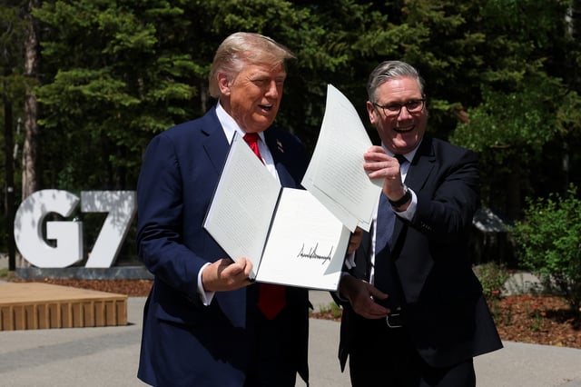 U.S. President Donald Trump and British Prime Minister Keir Starmer hold a signed Trade Agreement during a meeting, at the G7 summit, in Kananaskis, Alberta, Canada, June 16, 2025. REUTERS/Suzanne Plunkett/Pool/File Photo