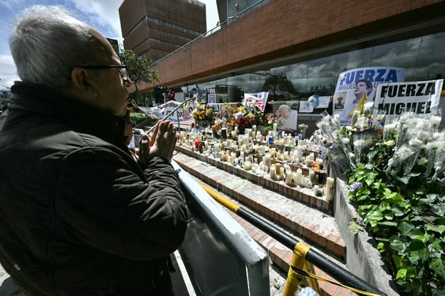 A man prays for the health of the Colombian presidential candidate Miguel Uribe during his surgery outside the Fundacion Santa Fe clinic in Bogota on June 16, 2025. Miguel Uribe, who was shot last week at a public event, underwent emergency surgery on June 16, 2025, due to "acute intracerebral bleeding", according to the clinic treating him.