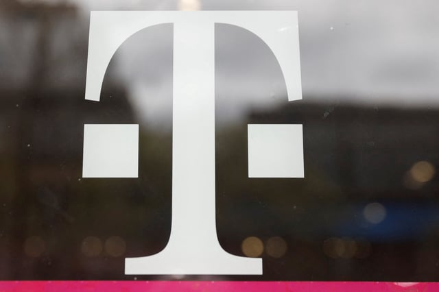 A T-Mobile logo is seen on the storefront door of a store in Manhattan, New York, U.S., April 30, 2018. REUTERS/Shannon Stapleton/File Photo