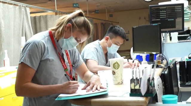 Staff doing charts inside the Royal Alexandra Hospital in Edmonton, Alta. on June 16, 2020.
