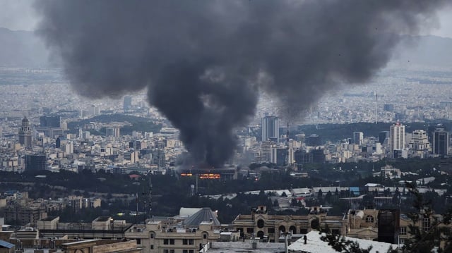 Smoke rises from the Iranian state TV building in Tehran after an Israeli strike. Photo: Stringer/Getty Images