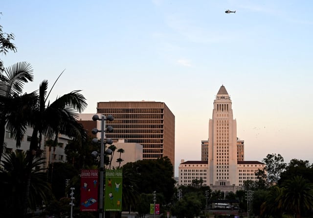 Darkness descends  as a helicopter flies over City Hall in Los Angeles shortly before curfew on Wednesday, June 11, 2025. (Photo by Keith Birmingham, Orange County Register/ SCNG)
