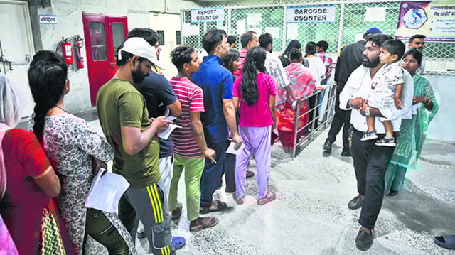People queue up to collect their Covid-19 test reports. (Sunil Ghosh / HT Photo)