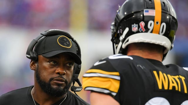 Pittsburgh Steelers head coach Mike Tomlin talks with outside linebacker T.J. Watt (90) against the Buffalo Bills during the second half at Highmark Stadium.