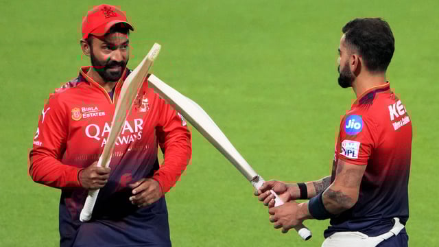 Dinesh Karthik, left, seen having a word with Virat Kohli