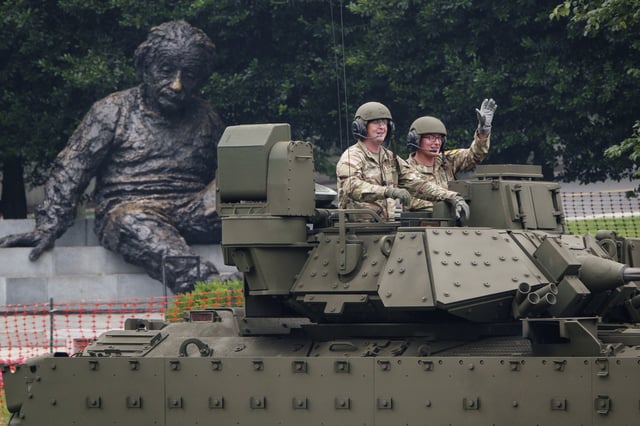 With the Albert Einstein Memorial statue in the background, members of the U.S. Army ride in a Bradley Fighting Vehicle during the 250th birthday parade on June 14, 2025, in Washington, D.C. (Photo by Kevin Carter/Getty Images)