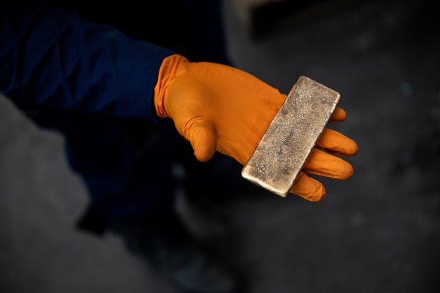 A worker holds a newly cast bar of gold at a refinery in London, Britain, April, 22, 2025. REUTERS/Chris J. Ratcliffe/File Photo
