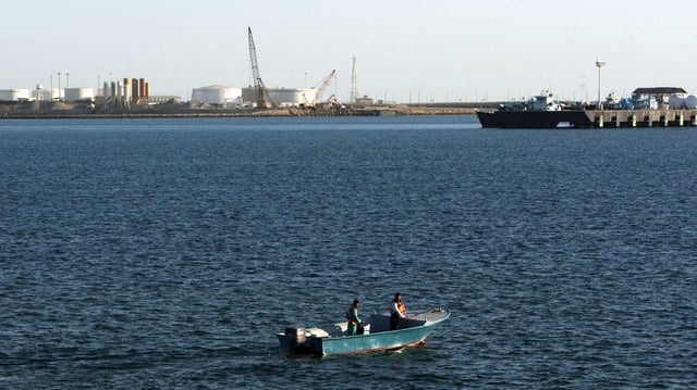 A speed boat passes by oil docks at the port of Kalantari in the city of Chabahar, east of the Strait of Hormuz. 