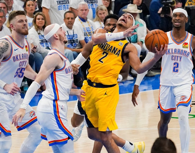 Game 5: The Indiana Pacers' Andrew Nembhard (2) collides with the Oklahoma City Thunder's Alex Caruso.