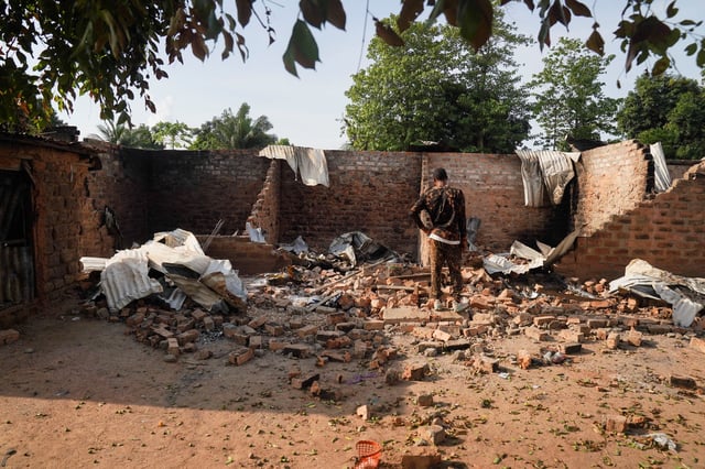 A man stands in front of a damaged and burnt house following a deadly gunmen attack in Yelewata, Benue State, Nigeria, June 16, 2025. REUTERS/Marvellous Durowaiye
