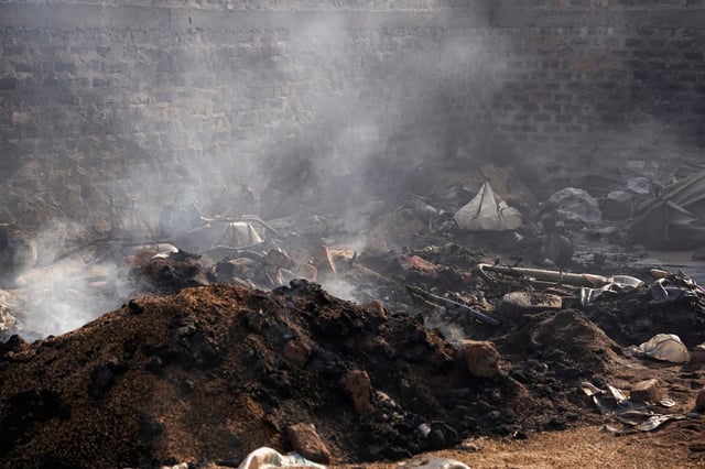 Burnt grains and farming equipment sit inside a storehouse following a deadly gunmen attack in Yelewata, Benue State, Nigeria, June 16, 2025. REUTERS/Marvellous Durowaiye