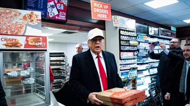Donald Trump picking up some pies while campaigning in Iowa last year