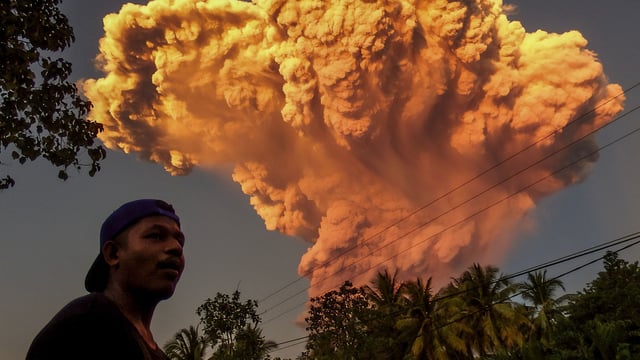 A villager watches the eruption of Mount Lewotobi Laki-Laki as seen from Talibura village in Sikka, East Nusa Tenggara, on June 17, 2025. (Photo by AFP)