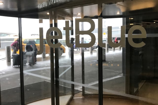 The JetBlue Airways logo is seen on a revolving door entering John F. Kennedy Airport in the Queens borough of New York U.S., January 24, 2017. REUTERS/Shannon Stapleton/File Photo
