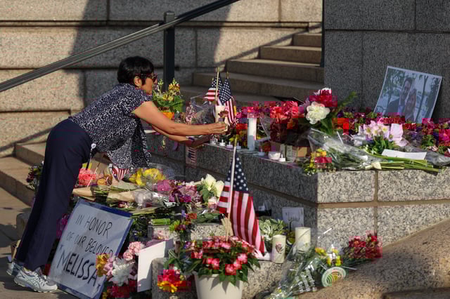 ST PAUL, MINNESOTA - JUNE 16: A woman lays flowers at a makeshift memorial for DFL State Rep. Melissa Hortman and her husband Mark Hortman at the Minnesota State Capitol building on June 16, 2025 in St. Paul, Minnesota. Law enforcement agencies captured a suspect in the killing of DFL State Rep. Melissa Hortman and her husband, Mark Hortman, who were shot at their home on June 14th. DFL State Sen. John Hoffman and his wife were also shot and hospitalized in a separate incident. Minnesota Gov. Tim Walz said during a press conference that the shooting &#34;appears to be a politically motivated assassination.&#34; (Photo by Steven Garcia/Getty Images)