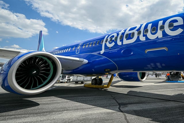 This photograph shows a Jetblue  aircraft at the ParisLe Bourget Airport, in Le Bourget, suburb of Paris on June 17, 2025.   