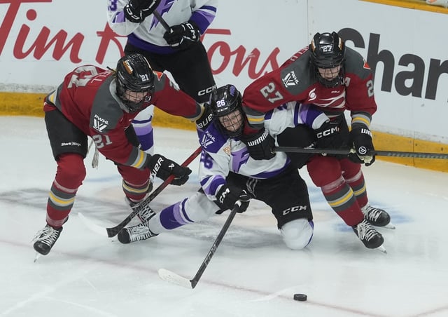 Ottawa Charge forward Shiann Darkangelo (right) and defence Ashton Bell (left) tie up Minnesota Frost forward Kendall Coyne Schofield (26) during third-period action in the PWHL final, Thursday, May 22, 2025, in Ottawa. THE CANADIAN PRESS/Adrian Wyld