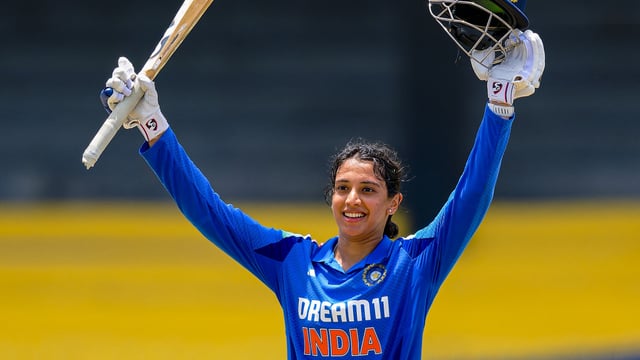 India's batter Smriti Mandhana celebrates her century during the 2025 Sri Lanka Women's Tri-Nation Series final cricket match against Sri Lanka