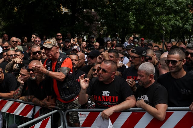 AC Milan 'ultras' supporters wait outside a high-security courtroom to show solidarity with fellow ultras awaiting a verdict in a court case involving soccer fans linked to both Inter Milan and AC Milan, who are suspected of having ties to the 'Ndrangheta mafia, in Milan, Italy,  June 17, 2025. REUTERS/Claudia Greco