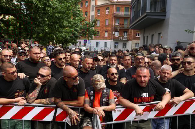 AC Milan 'ultras' supporters wait outside a high-security courtroom to show solidarity with fellow ultras awaiting a verdict in a court case involving soccer fans linked to both Inter Milan and AC Milan, who are suspected of having ties to the 'Ndrangheta mafia, in Milan, Italy, June 17, 2025. REUTERS/Claudia Greco