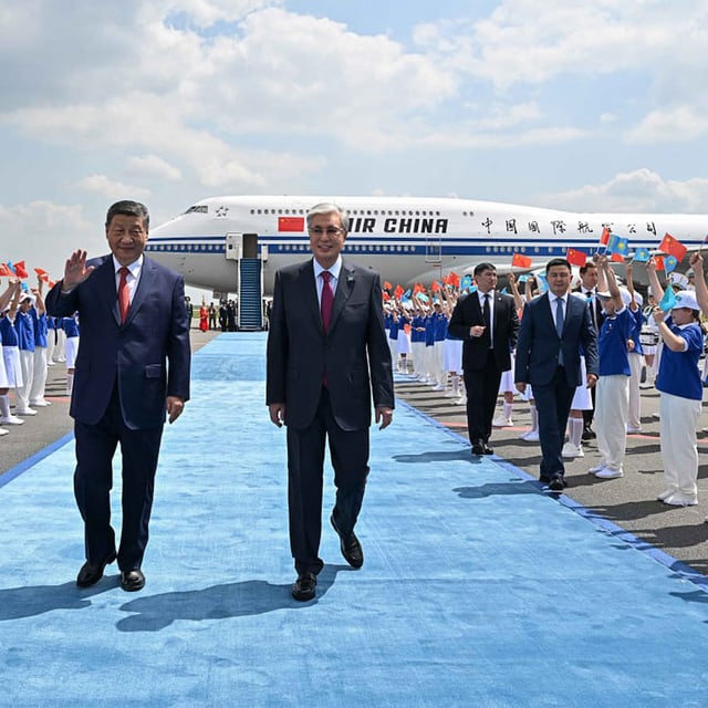 Kazakhstan's President Kassym-Jomart Tokayev, right, welcomes China's President Xi Jinping upon his arrival at the airport in Astana on June 16, in this photo supplied by Kazakhstan's Presidential Press Service.