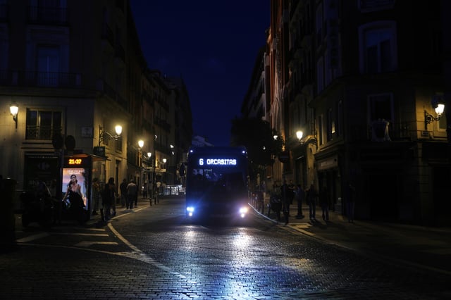 FILE - A bus drives in downtown Madrid during a major power outage, Monday, April 28, 2025. 