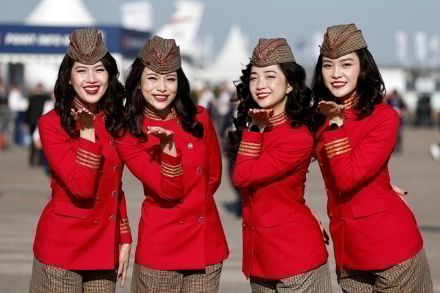 VietJet Air stewardesses pose at the 55th International Paris Airshow at Le Bourget Airport near Paris, France, June 17, 2025. REUTERS/Benoit Tessier