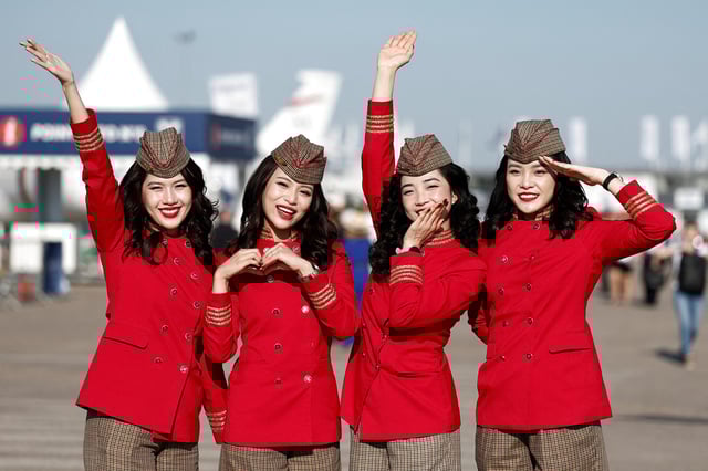 VietJet Air stewardesses pose at the 55th International Paris Airshow at Le Bourget Airport near Paris, France, June 17, 2025. REUTERS/Benoit Tessier