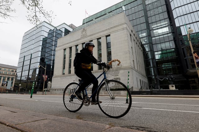 A cyclist rides past the Bank of Canada building in Ottawa, Ontario, Canada May 8, 2025. REUTERS/Blair Gable/File Photo