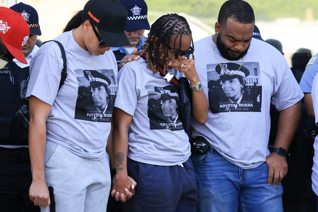 Police officers wear T-shirts with a picture of Officer Krystal Rivera during a prayer vigil in her memory at the 6th District station, June 11, 2025, in Chicago. Rivera was fatally shot on June 5 by another officer as they responded to an investigation. (John J. Kim/Chicago Tribune)