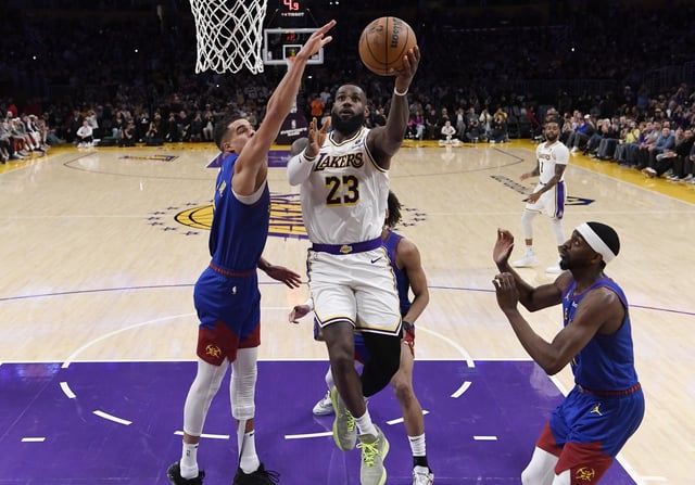 LeBron James #23 of the Los Angeles Lakers scores his 40,000th career point during the first half against Michael Porter Jr. #1 of the Denver Nuggets at Crypto.com Arena. James has won four championships in his career.