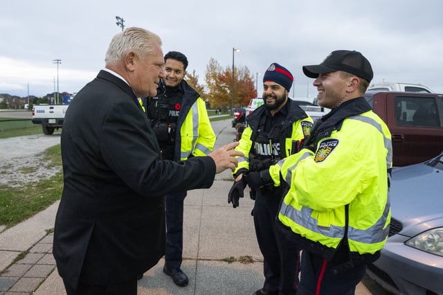 Premier Doug Ford speaks with members of the Peel Region Police during the Diwali Mela festival at Sesquicentennial Park in Brampton, Ont., Friday, Nov. 1, 2024. 
