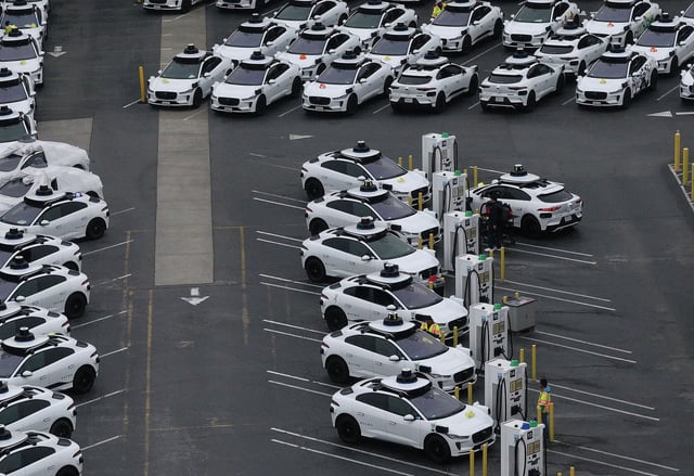 In an aerial view, Waymo cars are seen parked on June 10, 2025, in San Francisco. The robotaxi company limited its service in the city amid anti-ICE protests, after several Waymo cars were set on fire and destroyed in Los Angeles.