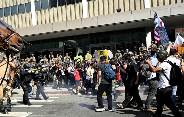 A object is thrown towards the police as protesters face off with LAPD as they push them back from the Edward R. Roybal Federal Building during the ‘No Kings’ protests in Los Angeles on Saturday, June 14, 2025. (Photo by Keith Birmingham, Orange County Register/ SCNG)