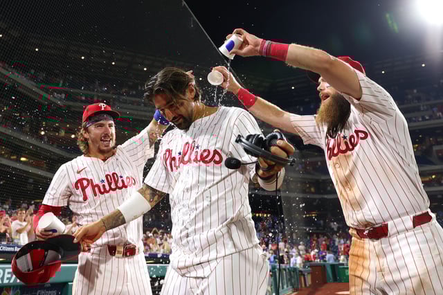 Nick Castellanos #8 of the Philadelphia Phillies is doused with water during his postgame interview after winning against the Houston Astros at Citizens Bank Park on August 27, 2024 in Philadelphia, Pennsylvania.