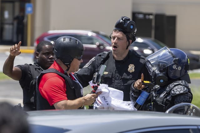 Police tell Spanish-language reporter Mario Guevara to move back during a protest on ICE raids and deportation arrests on Chamblee Tucker Road in Atlanta on Saturday, June 14, 2025.