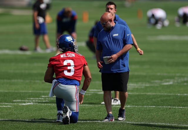 Brian Daboll, Head Coach of the New York Giants talks with Russell Wilson #3 of the New York Giants during a New York Giants practice session at NY Giants Quest Diagnostics Training Center on June 12, 2025 in East Rutherford, New Jersey.