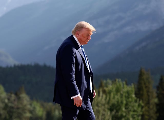 U.S. President Donald Trump leaves after a family photo session during the G7 Summit, in Kananaskis, Alberta, Monday, June 16, 2025. (Suzanne Plunkett/Pool Photo via AP)