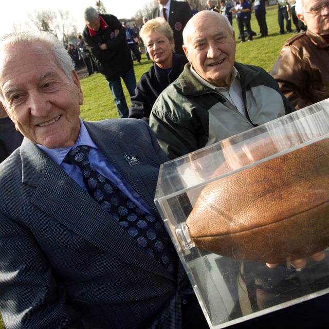 Nick Volpe, who played in the original Mudbowl, holds the ball from that game in Toronto in November, 2012.