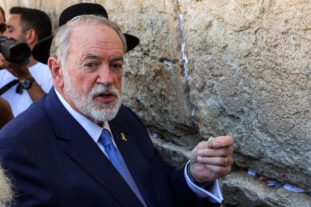 The U.S.' new ambassador to Israel Mike Huckabee holds a note given to him from President Donald Trump to be placed in the cracks of the Western Wall, the holiest site where Jews are allowed to pray, during Huckabee's visit to the holy site in the old city of Jerusalem on April 18, 2025.